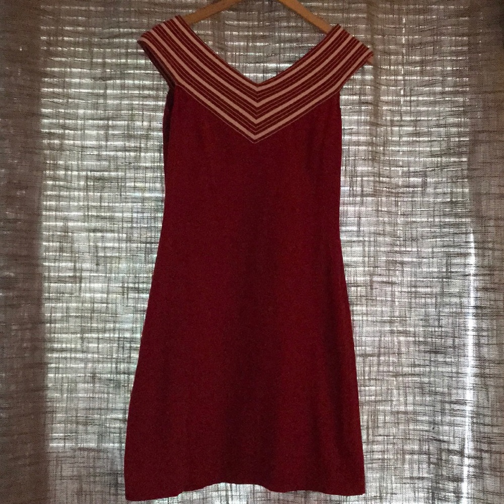 Form fitting red off the shoulder dress.